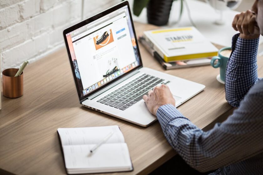 Man sitting at a desk and working on a laptop