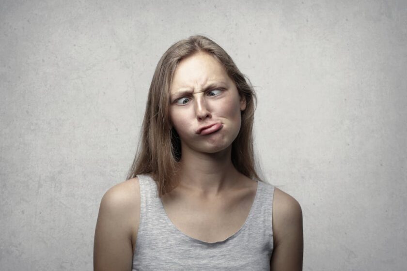 puzzled woman in vest top