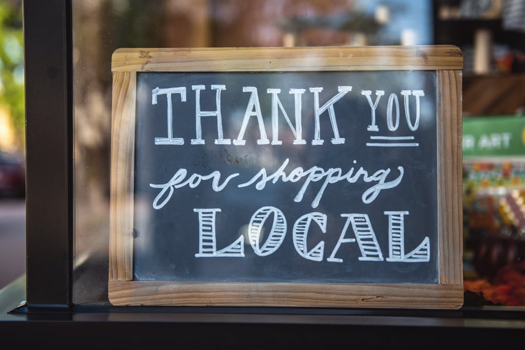 Wooden sign that says "thank you for shopping local"
