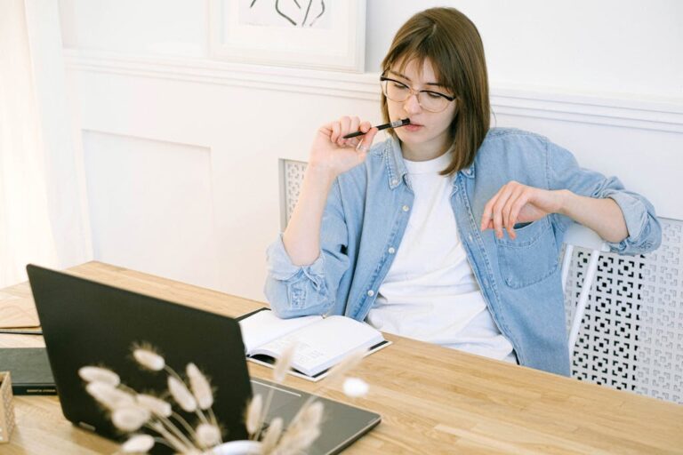 Woman sitting at a desk writing notes in a notebook